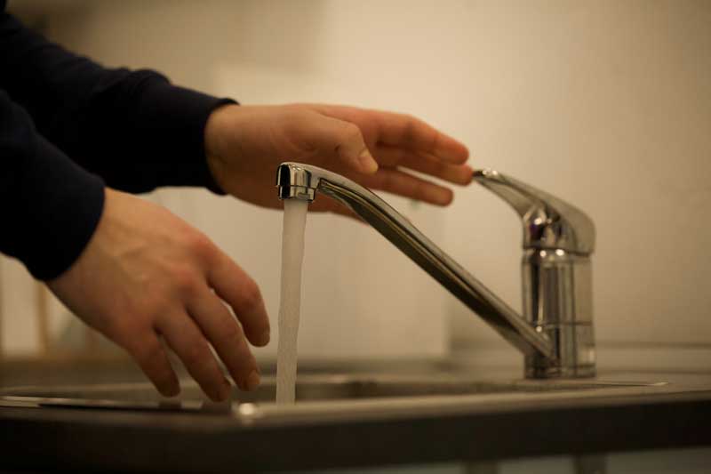 Someone washing their hands in a sink